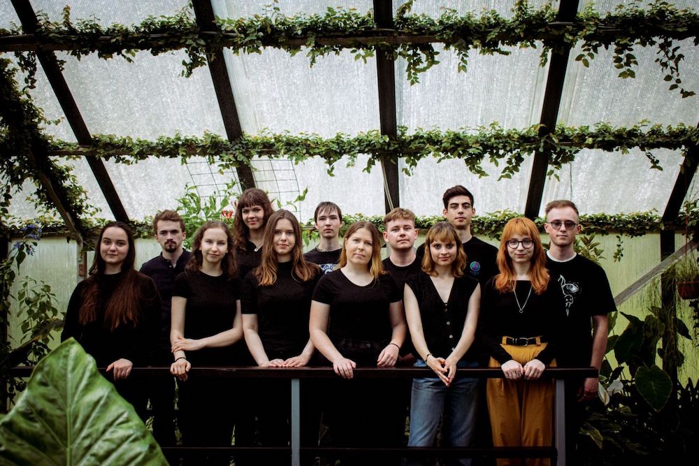 The iGEM Latvia Riga team poses in a greenhouse
